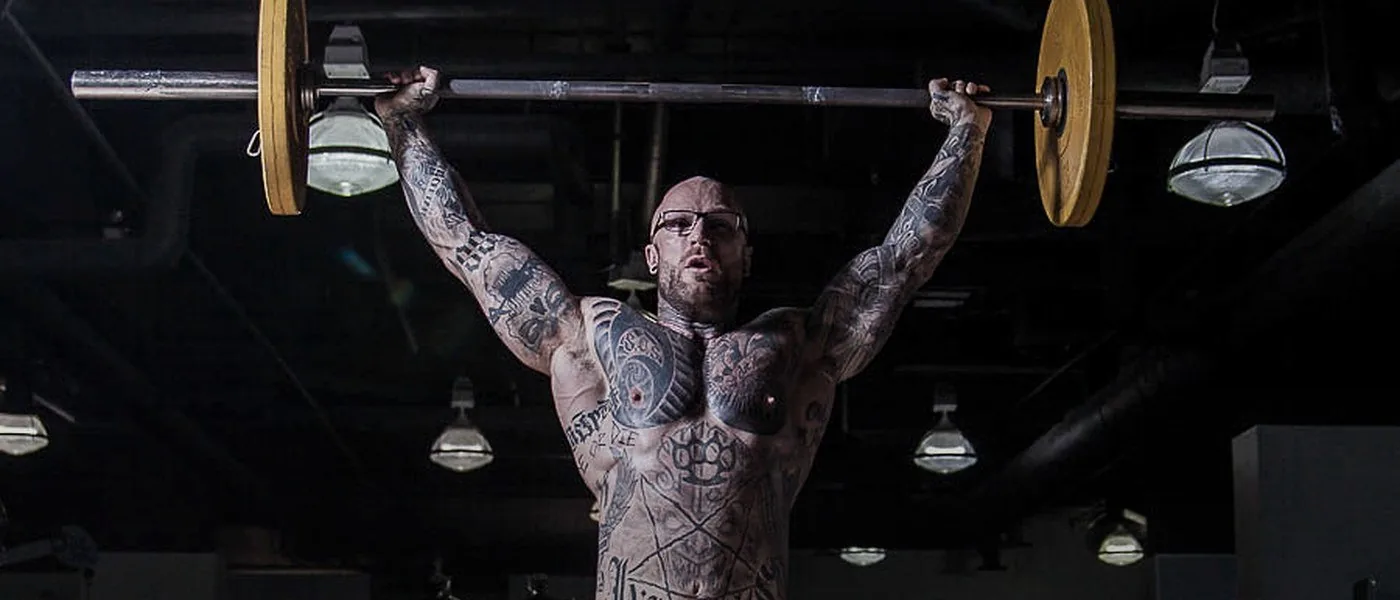 Jordan Hoelscher performing an overhead press